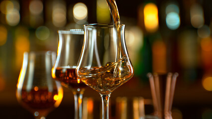 Close-up of pouring whiskey or rum in a pub