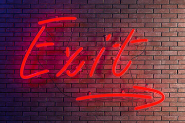 On a brick wall there is a glowing red neon sign with the inscription exit with an arrow towards daylight. Loft interior style. 3d rendering.