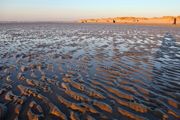 Sands flats exposed at low tide at West Wittering, West Sussex, UK.