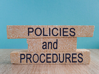Policies vs procedures symbol. Beautiful wooden table, blue background, copy space. Business,...