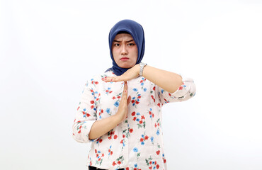 Asian muslim woman standing while making time out hand gesture. Isolated on white background