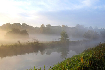 Fototapeta na wymiar Mist over the meadows of the River Wey, Guildford, Surrey, UK