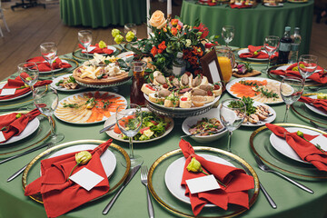 A variety of dishes and snacks on the banquet table with a beautiful decor.