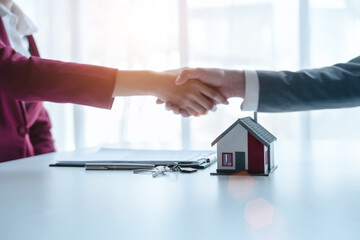 Shaking hands Businessperson real estate purchase agreement contract after sign official offer form is created by the homebuyer's agent and submitted to the seller