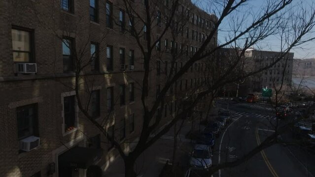 rising over concave NYC apartment building revealing George Washington Bridge