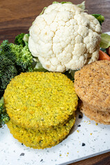 Uncooked fresh vegan and vegetarian burgers made from fresh vegetables and dried legumes and beans