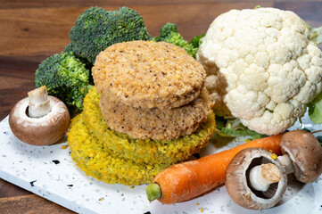 Uncooked fresh vegan and vegetarian burgers made from fresh vegetables and dried legumes and beans