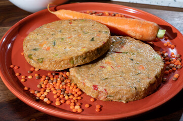 Uncooked fresh vegan and vegetarian burgers made from fresh vegetables and dried legumes and beans