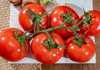 Red ripe tasty Dutch tomatoes growing indoor in greenhouse all seasons, food industry in Netherlands