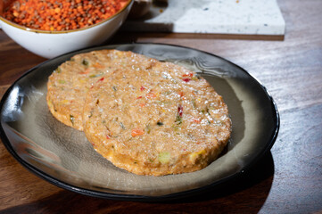 Uncooked fresh vegan and vegetarian burgers made from fresh vegetables and dried legumes and beans