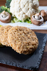 Uncooked fresh vegan and vegetarian burgers made from fresh vegetables and dried legumes and beans
