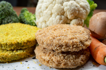 Uncooked fresh vegan and vegetarian burgers made from fresh vegetables and dried legumes and beans