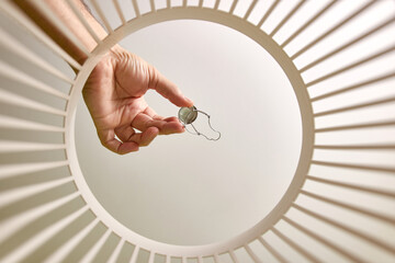 A wire basket for champagne is thrown into the trash. View from below. The concept of recycling and...