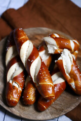 Fresh pretzels on a wooden tray. Straight flat pretzels.