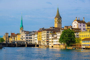 Scenic panoramic view of historic Zürich city center with famous Fraumünster and Grossmünster Church and river Limmat at Lake Zurich on a beautiful sunny day with blue sky in summer, Switzerland