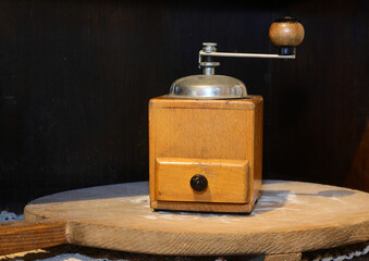 old wooden coffee grinder to pulverize the beans and prepare the drink with drawer