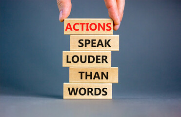 Actions speak louder words symbol. Concept words Actions speak louder than words on wooden blocks....