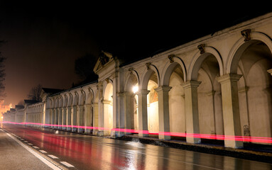Fototapeta premium Red streak left by the car lights and the ancient arcades leading to the Basilica called DI MONTE BERICO in the City of Vicenza in Italy