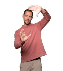 Friendly young man making a gesture of taking a photo with the hands