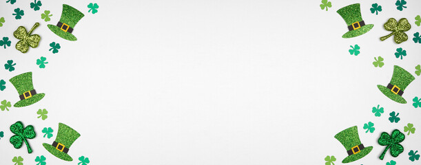 St Patricks Day shamrock and green leprechaun hat double border. Above view over a white banner background with copy space.