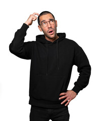 Fototapeta premium Concerned young man doing a gesture of confusion