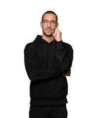 Satisfied young man with crossed arms gesture