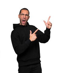 Cool young man pointing with his fingers