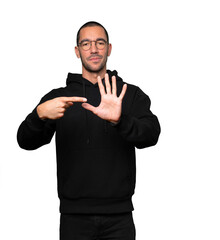 Young man pointing to his wrist