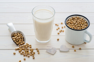soya milk in a glass, beans around, plant based and vegan