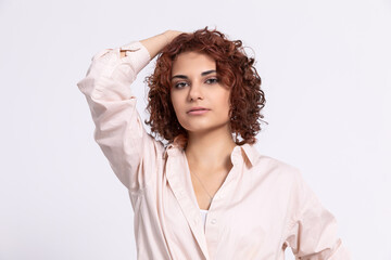 Portrait of a girl with a serious expression on her face. Short curly hair.