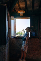 Young beautiful woman visits the sights of the Republic of San Marino, Italy