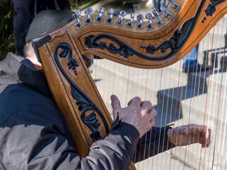musician playing the harp in the street
