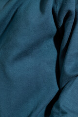 Fototapeta premium Unrecognizable person in a blue sweater. Extreme close-up.
