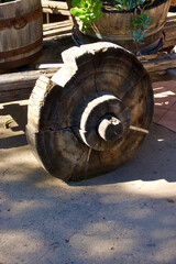 side view of damaged wooden cart wheel