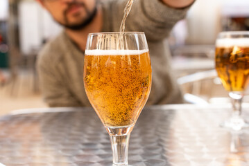 Man pouring beer into a glass