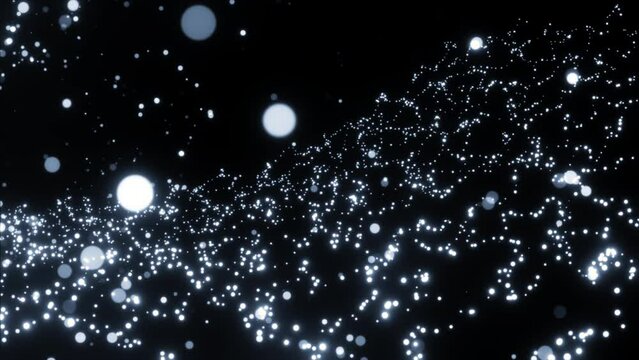 Flying round shaped particles on a black background. Motion. Beautiful spheres in outer space, glowing balls.