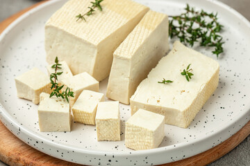 soy cheese tofu diced on a light background, Healthy vegan meatless meal rich in protein and calcium. Food recipe background. Close up