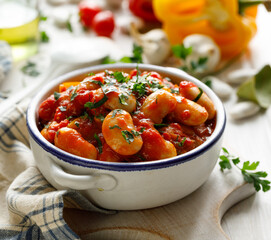 Vegetable stew with beans, tomatoes and peppers sprinkled with fresh parsley, close up view