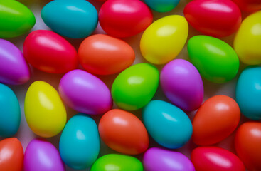 Background from multi-colored Easter eggs. Easter holiday concept. Lots of eggs. Bright Easter background. Plastic decorative home decoration for spring holidays.