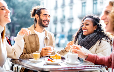 Fototapeta Young couples drinking cappuccino at coffee bar patio - Friends talking and having fun together at sidewalk cafeteria - Life style concept with young men and women at cafe dehor - Bright vivid filter obraz