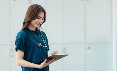 Portrait of young female doctor standing in hospital.