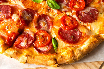 Traditional pizza served on wooden plate. Close-up