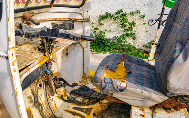 Old white broken wrecked tuk tuk rikshaw wreck in Mexico.