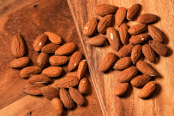 Almonds nuts on a wooden plate. Close up photo with almonds healthy food.