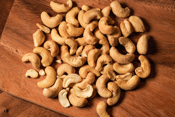 Cashew nuts from above. Close up photo with cashew on a wooden plate.