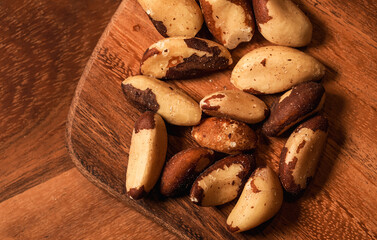 Brazilian nuts on a wooden table. Macro photo with healthy nuts rich in Selenium and other vitamins and proteins.