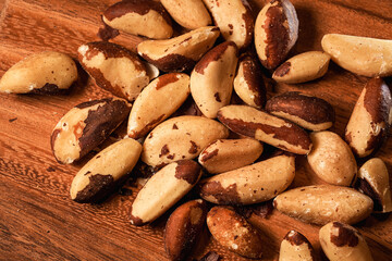 Brazilian nuts on a wooden table. Close up photo of this healthy nuts rich in Selenium and other vitamins and proteins.