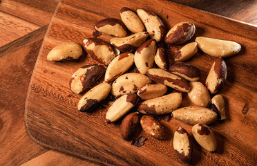 Close up photo of this healthy nuts rich in Selenium and other vitamins and proteins. Brazilian nuts on a wooden table. 