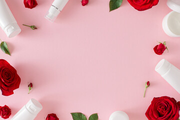 Women's day presents concept. Flat lay photo of cosmetic bottles, red roses, green leaves on pastel...