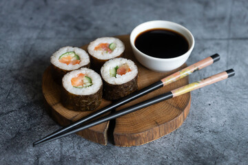 Freshly cooked sushi on a dark background.